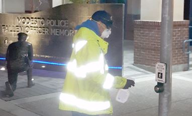 Employee Disinfecting Crosswalk Button