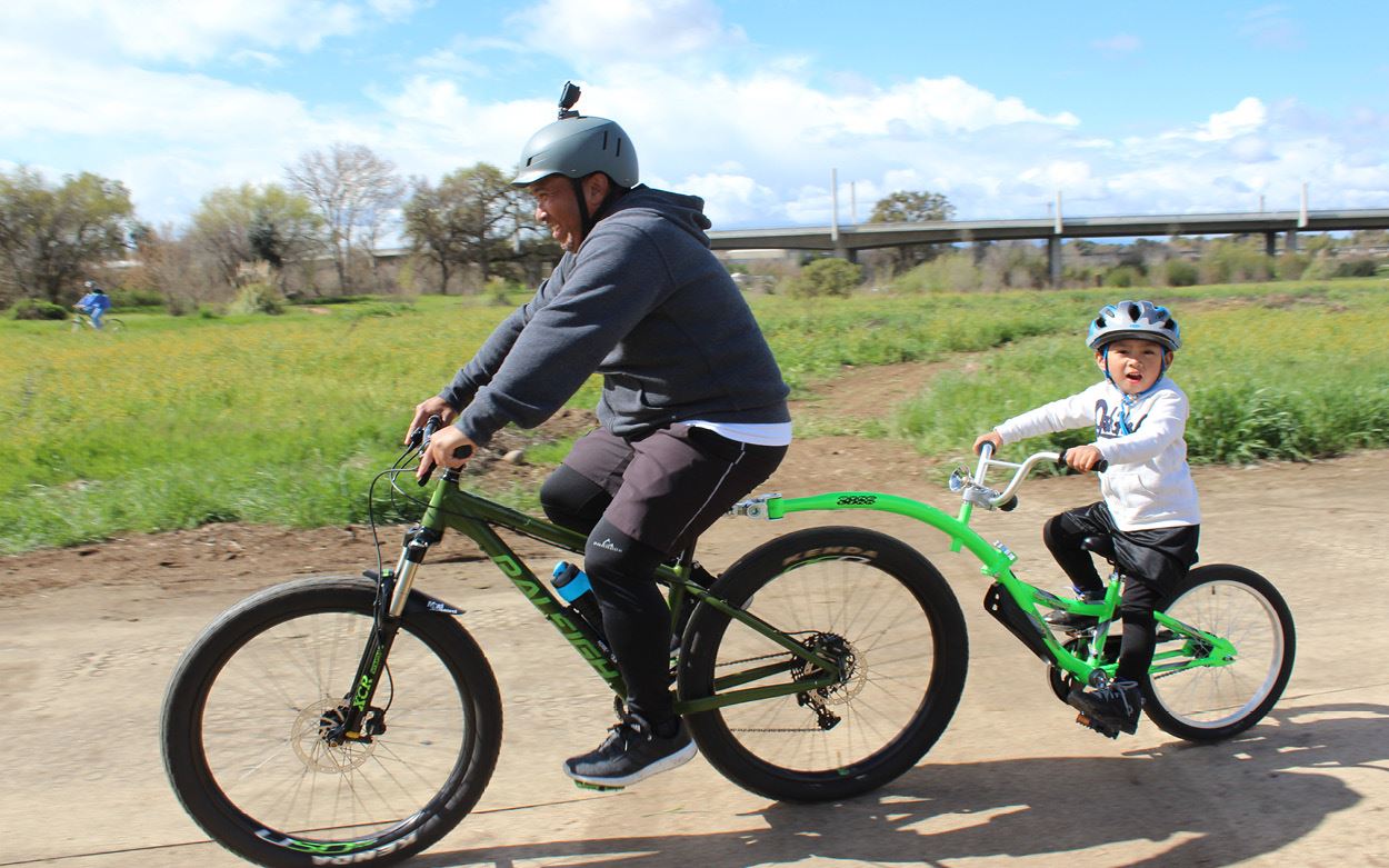 Color image of four children posing on their mountain bikes 