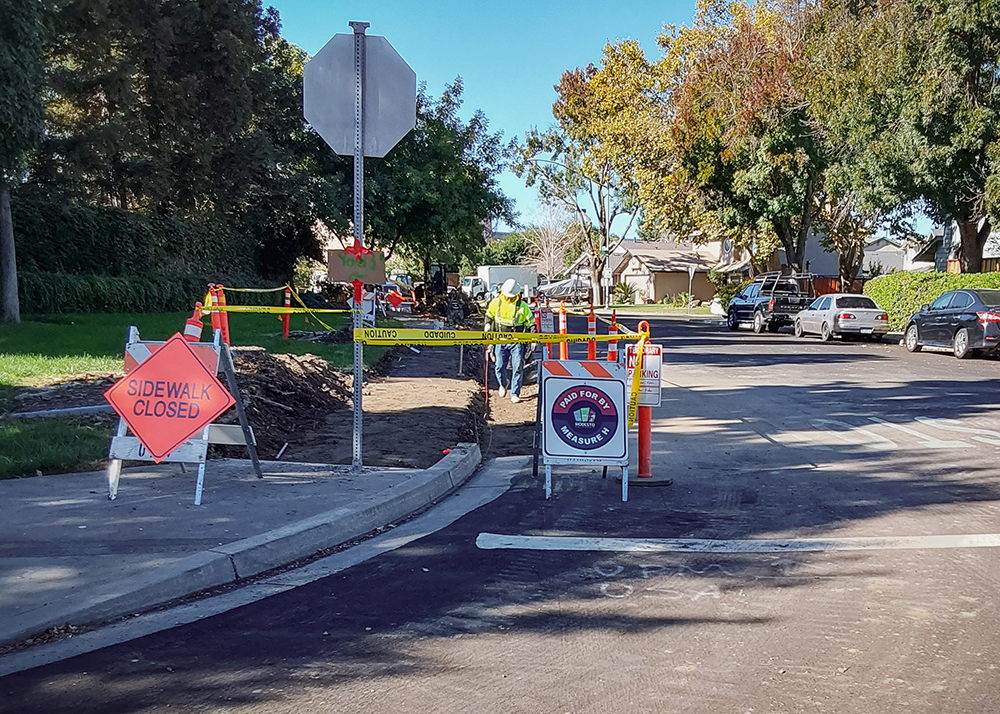 Construction of new sidewalks with a paid for by Measure H sign.