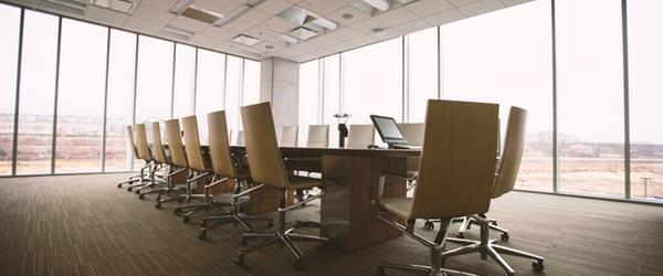 Image of long table and chairs in meeting space