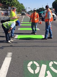 Public Works Personnel Apply Paint Signs on the Road