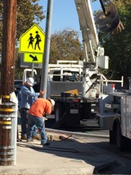 Public Works Personnel Installing Street Light